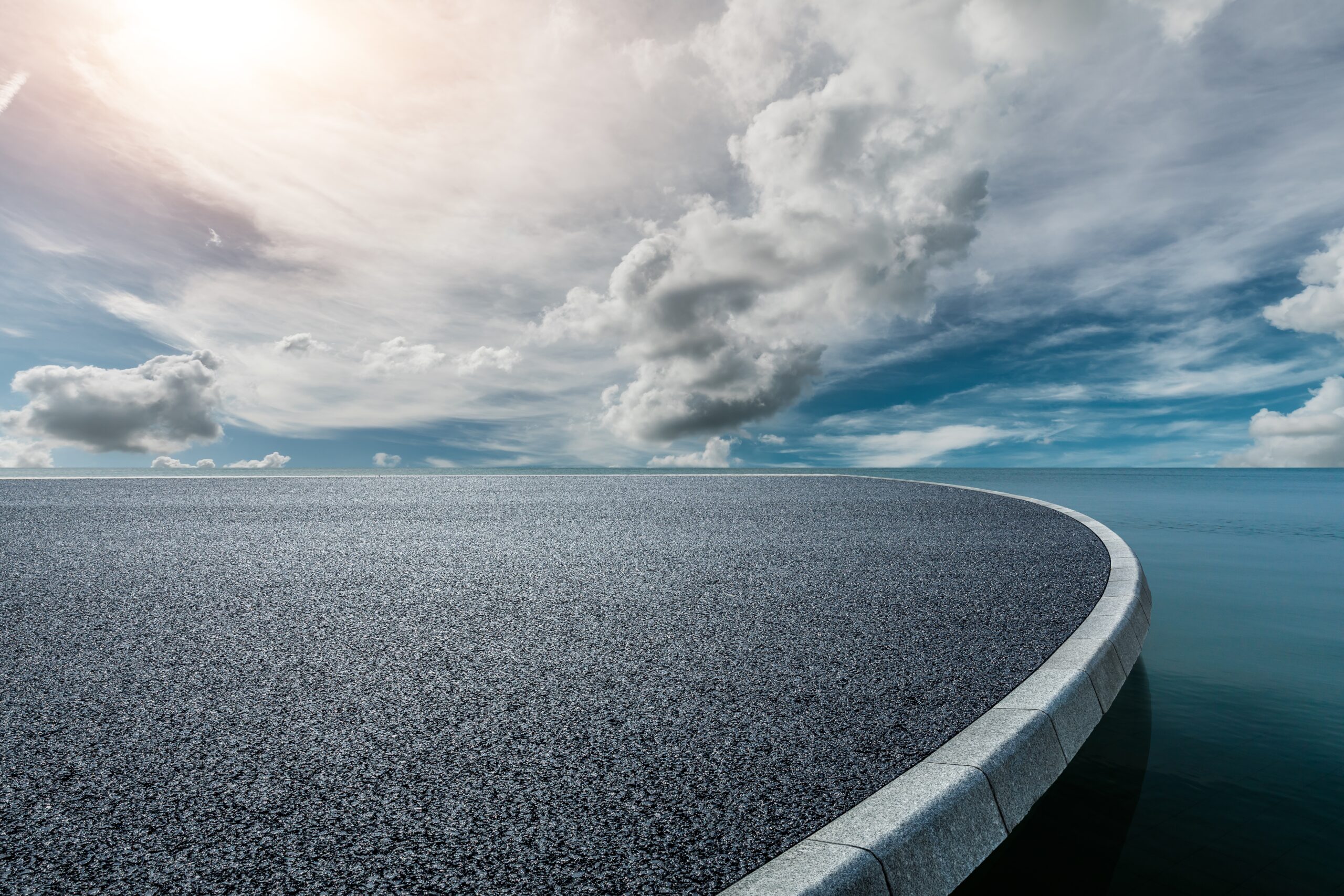 Round,Asphalt,Road,Platform,Near,The,Lake,Under,Blue,Sky