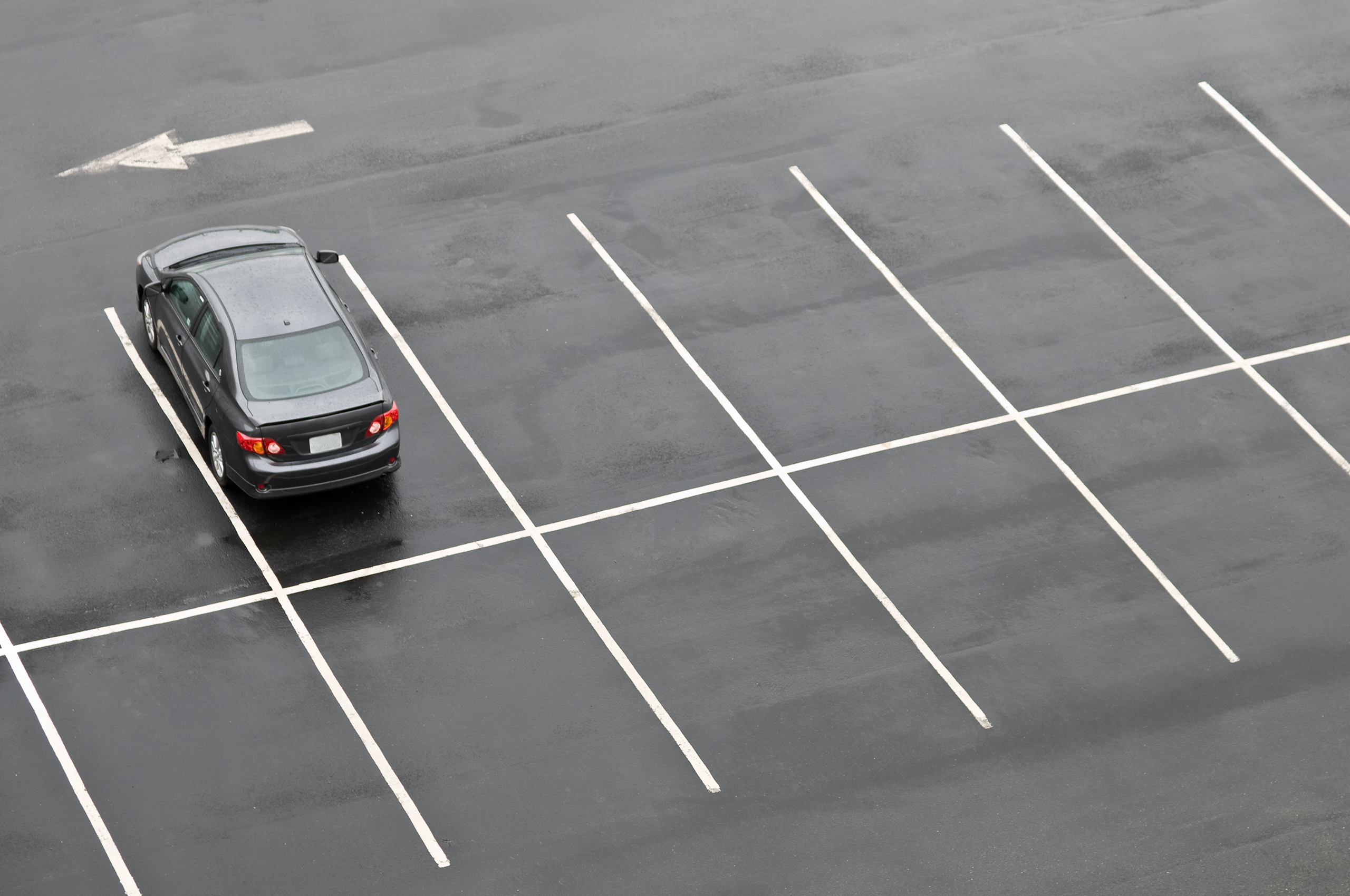 Single,Car,In,Otherwise,Empty,Parking,Lot,,In,The,Rain