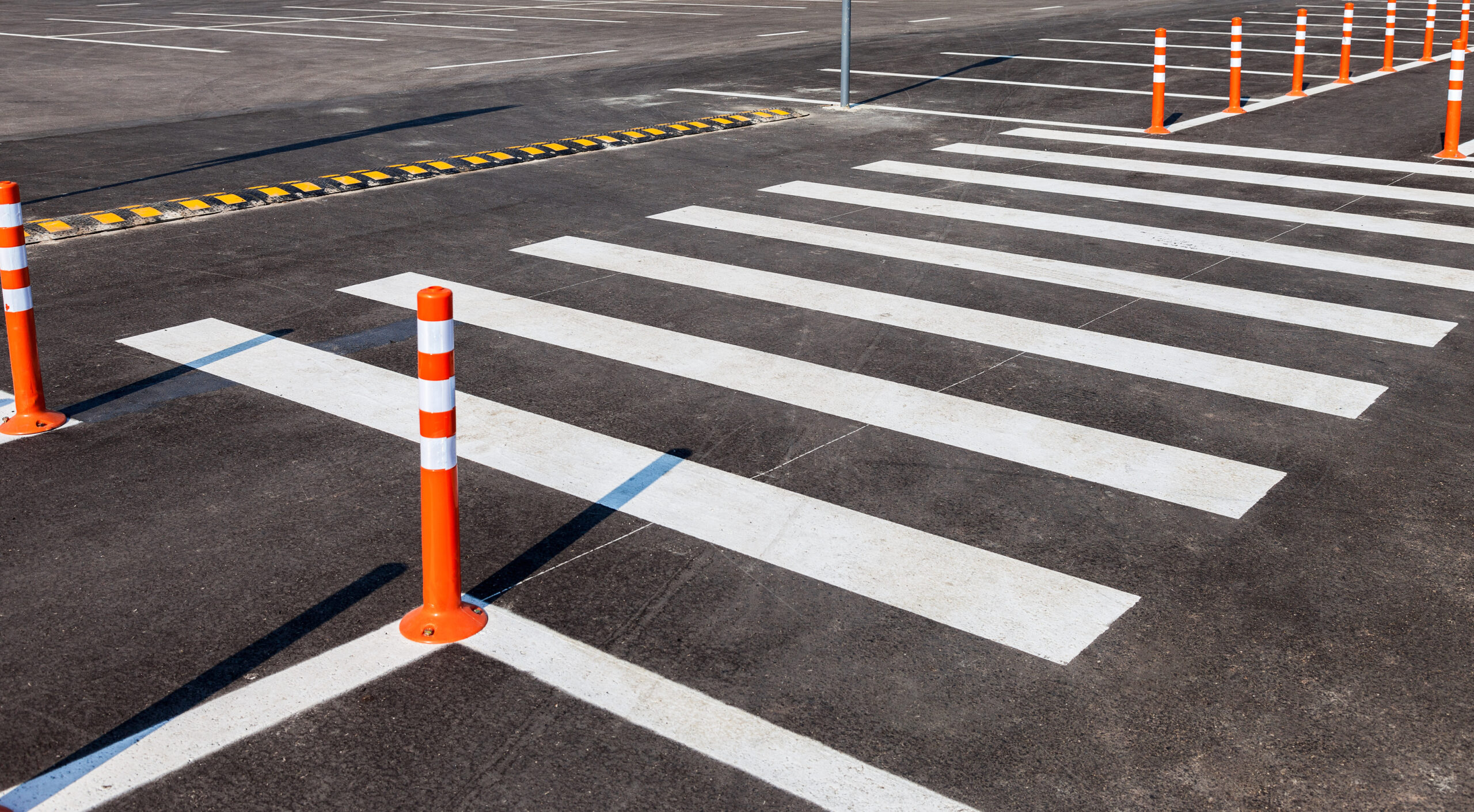 White,Traffic,Markings,With,A,Pedestrian,Crossing,On,A,Gray